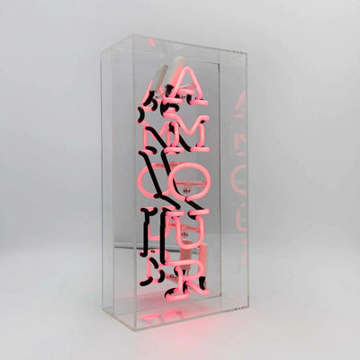 TOM NEON Glas Neon Box 'Amour'. Stilvolle Neonbeleuchtung mit dem Wort 'Amour' in einer eleganten Glasbox. Perfekt für eine romantische und moderne Raumdekoration.